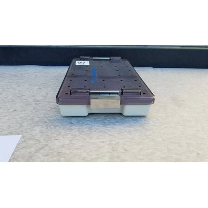 Dark purple transparent plastic radionics surgical sterlization case tray with silver metal latch and white base