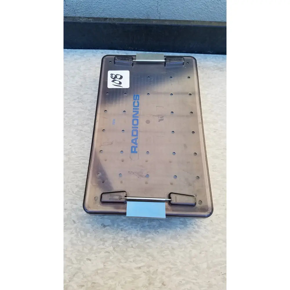 Transparent brown plastic radionics surgical sterlization case tray with grid holes and blue branding for sterlization use