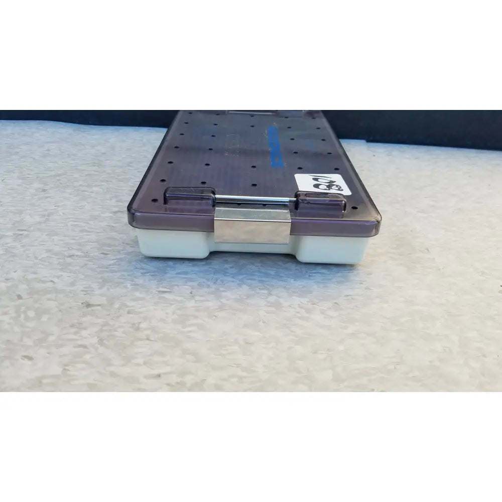 Purple and white plastic radionics surgical sterlization case tray with a metallic clasp for secure surgical sterlization use