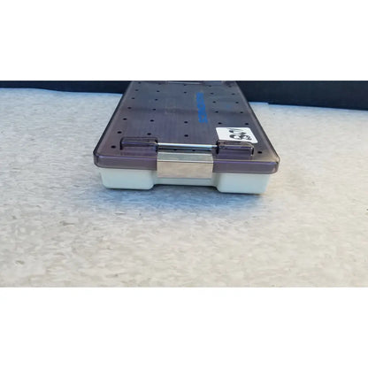 Purple and white plastic radionics surgical sterlization case tray with a metallic clasp for secure surgical sterlization use