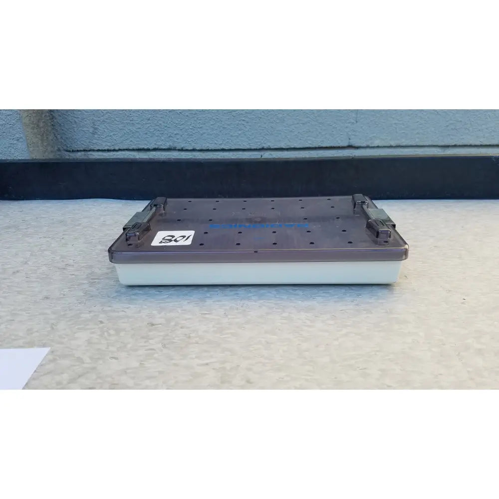 Dark gray plastic radionics surgical sterlization case tray with white base and perforated top surface for sterlization use