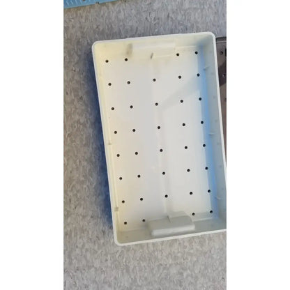 White plastic radionics surgical sterlization case tray with evenly spaced circular holes for instrument organization