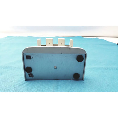 White plastic rapid charge stand with four vertical slots and black rubber feet for rainin e3 rapid charging