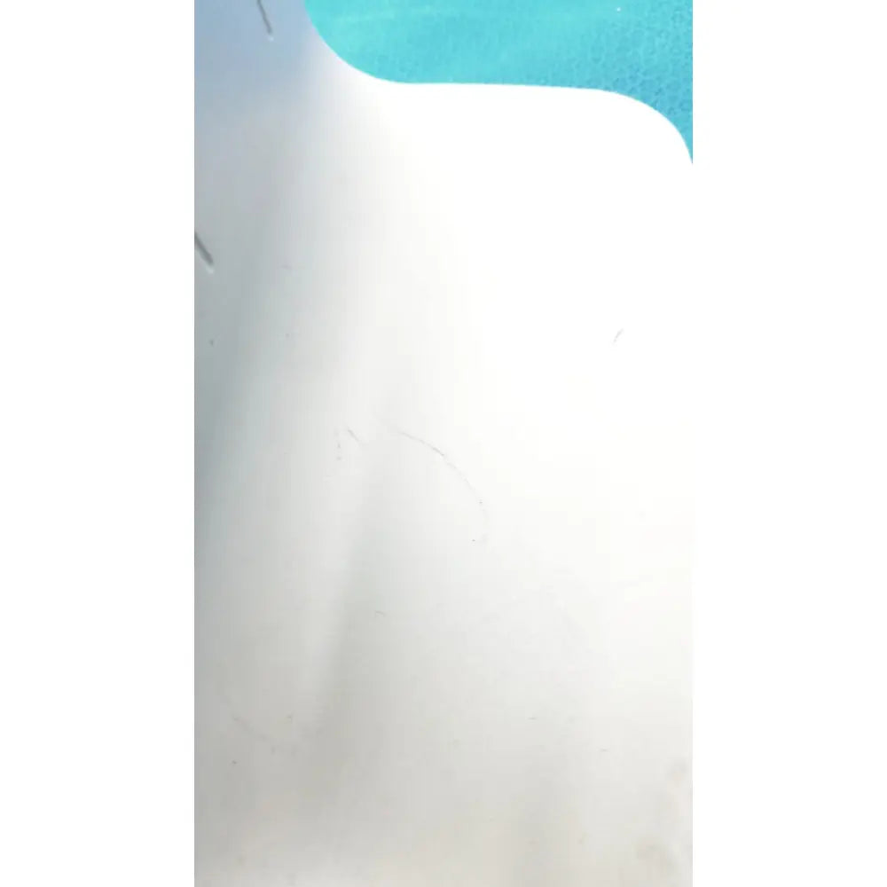 White plastic pool liner with faint scuff marks and curved edge in turquoise water for rainin e3 rapid charge stand