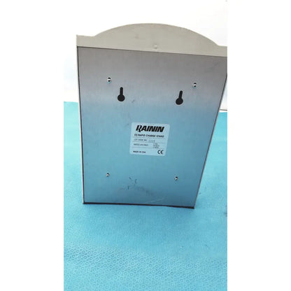 Silver metallic rainin e3 rapid charge stand with four mounting holes and a curved top for efficient rapid charge use