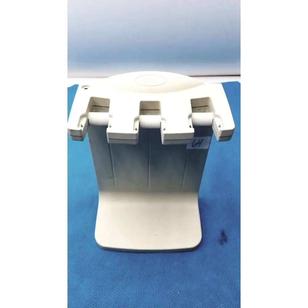 Off-white plastic dental handpiece holder with three adjustable slots for rainin e3 rapid charge stand rapid charge use