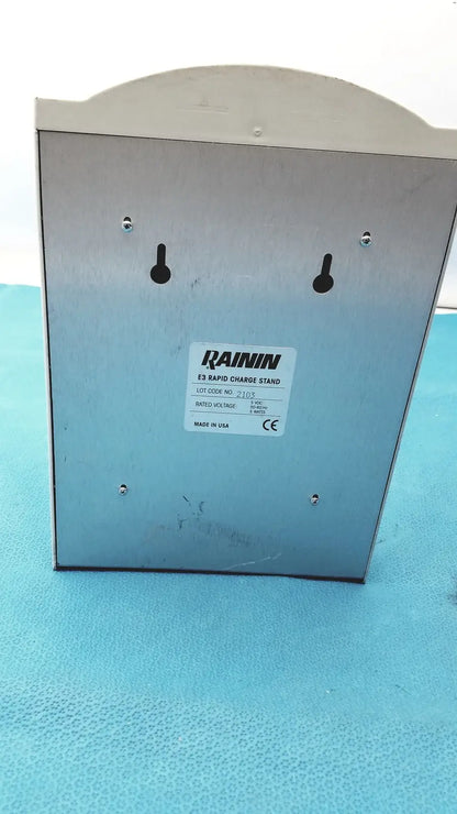 Silver metallic rainin e3 rapid charge stand with four mounting holes and a curved top for efficient rapid charge use