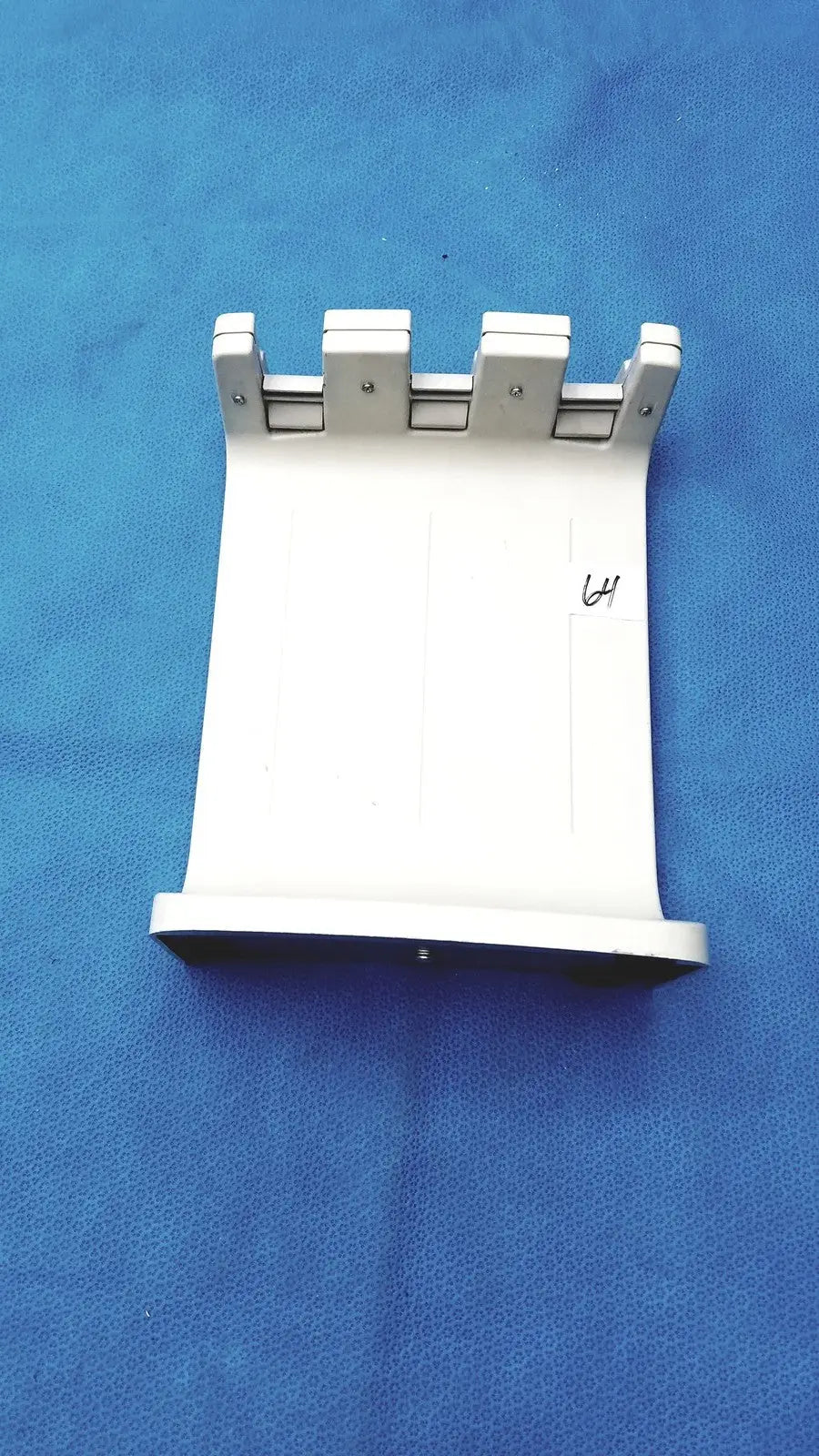 White plastic mounting bracket with four silver metal clips for rainin e3 rapid charge stand accessory