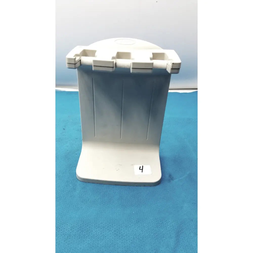 White plastic toothbrush holder with four slots and vertical ridges for the Rainin E3 Rapid charger stand