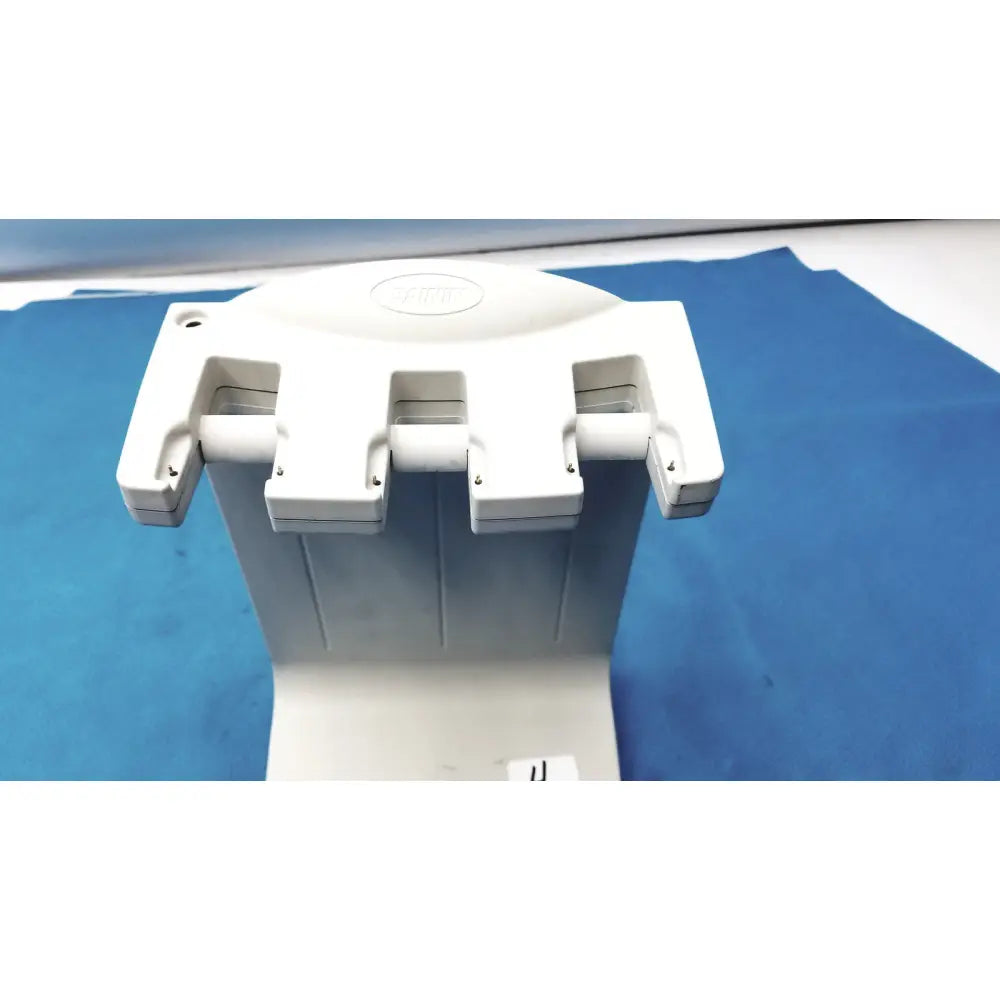 White plastic dental handpiece holder with three adjustable slots for instruments in rainin e3 rapid charger stand