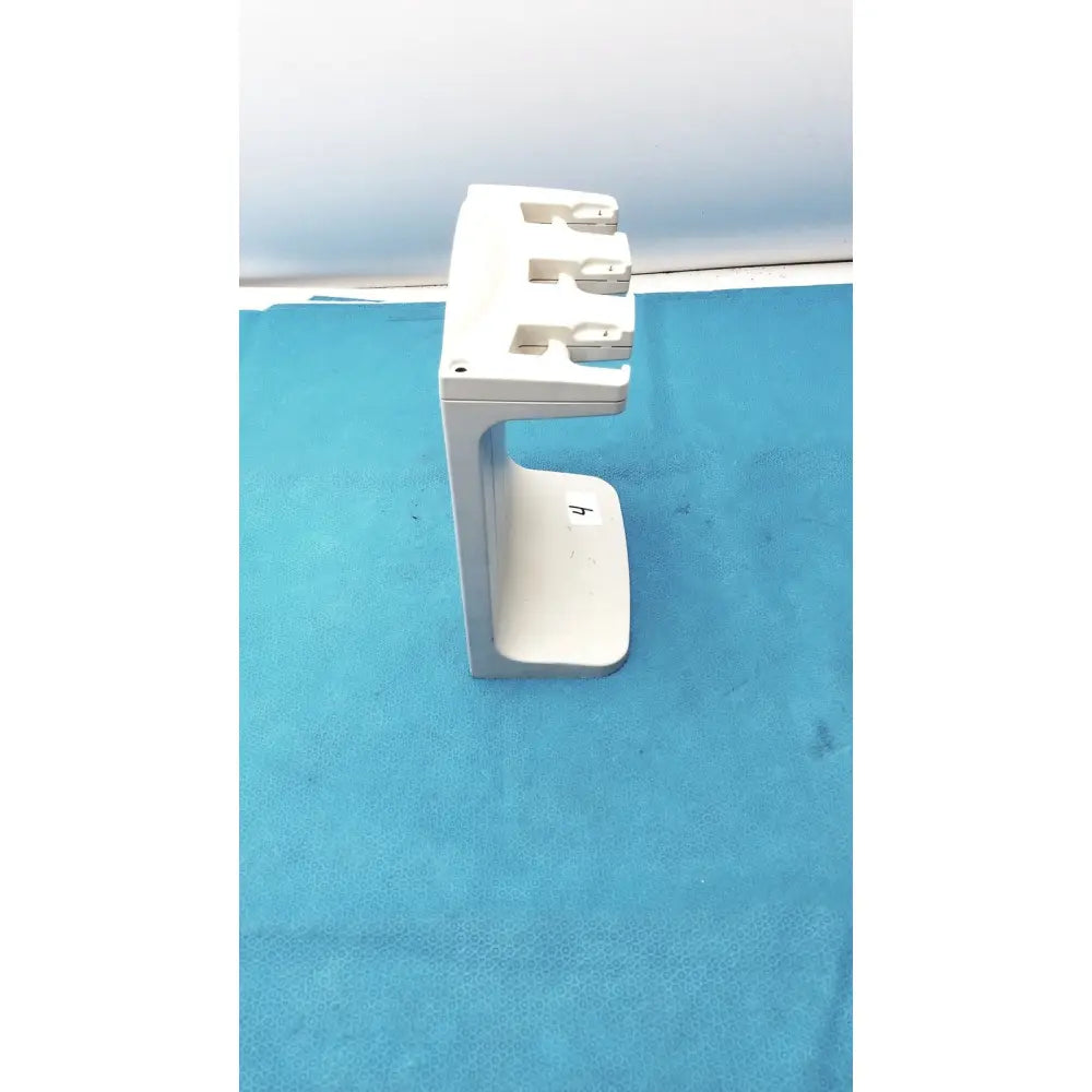 White plastic rainin e3 rapid charger stand with three slots for charging devices in a rapid charger design