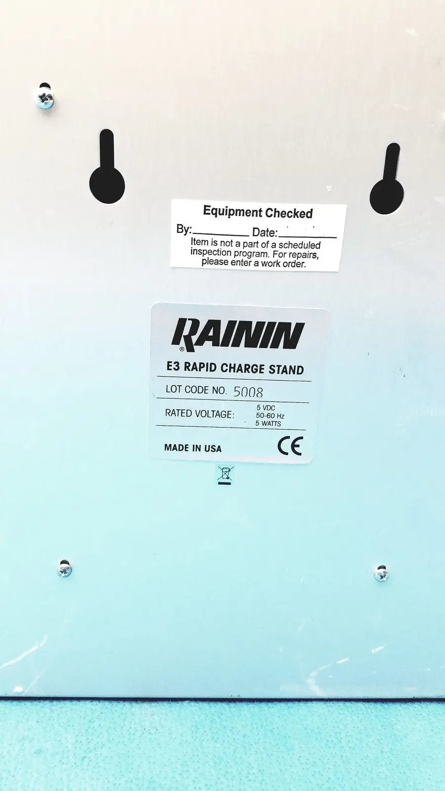 Light blue rainin e3 rapid charger stand with black mounting holes and white label showing technical specifications
