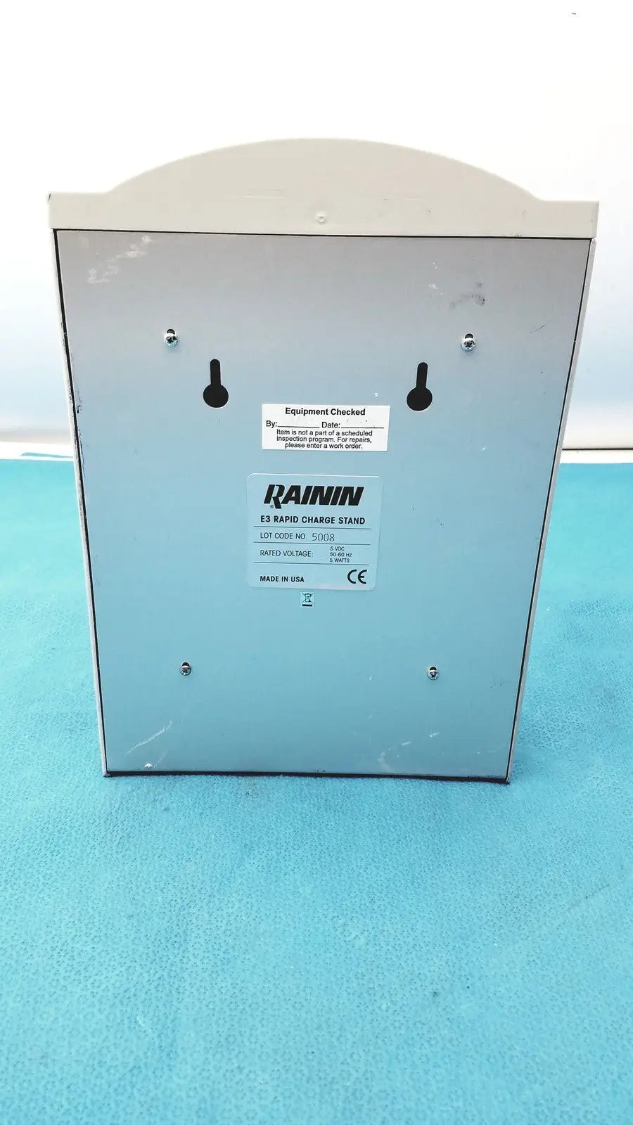 Light gray metallic rainin e3 rapid charger stand with curved top and mounting holes for secure installation