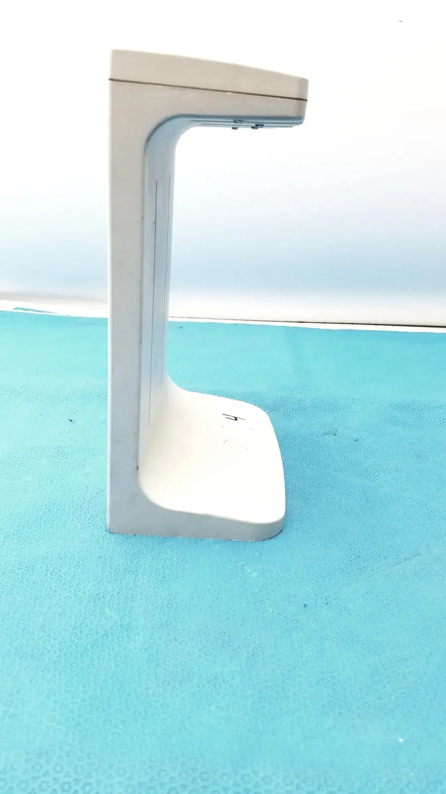 White plastic rainin e3 rapid rapid charger stand with sleek minimalist design and curved support arm
