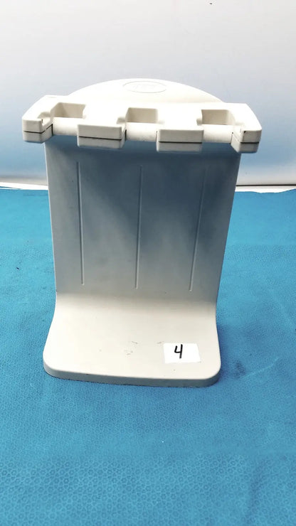 White plastic toothbrush holder with four slots and vertical ridges for the Rainin E3 Rapid charger stand