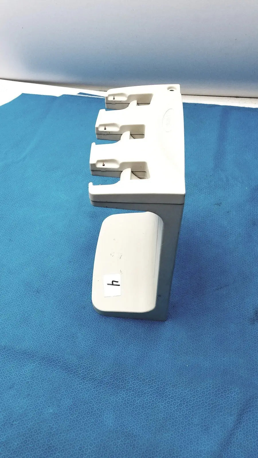 White plastic rainin e3 rapid charger stand with three slots and a small compartment for rapid charger organization