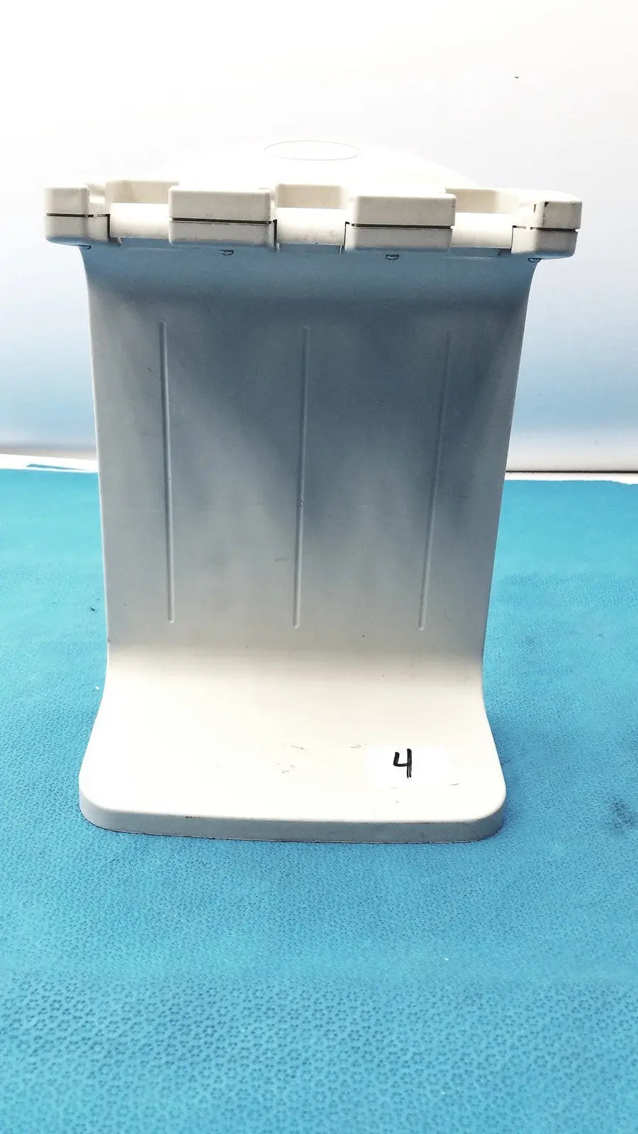 White plastic rainin e3 rapid charger stand with ribbed front panel and segmented top lid for efficient charging