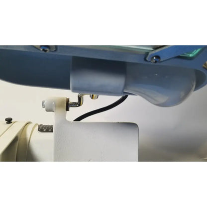 Blue industrial sewing machine with white needle and metallic parts in ray foster high speed dental alloy grinder ag05
