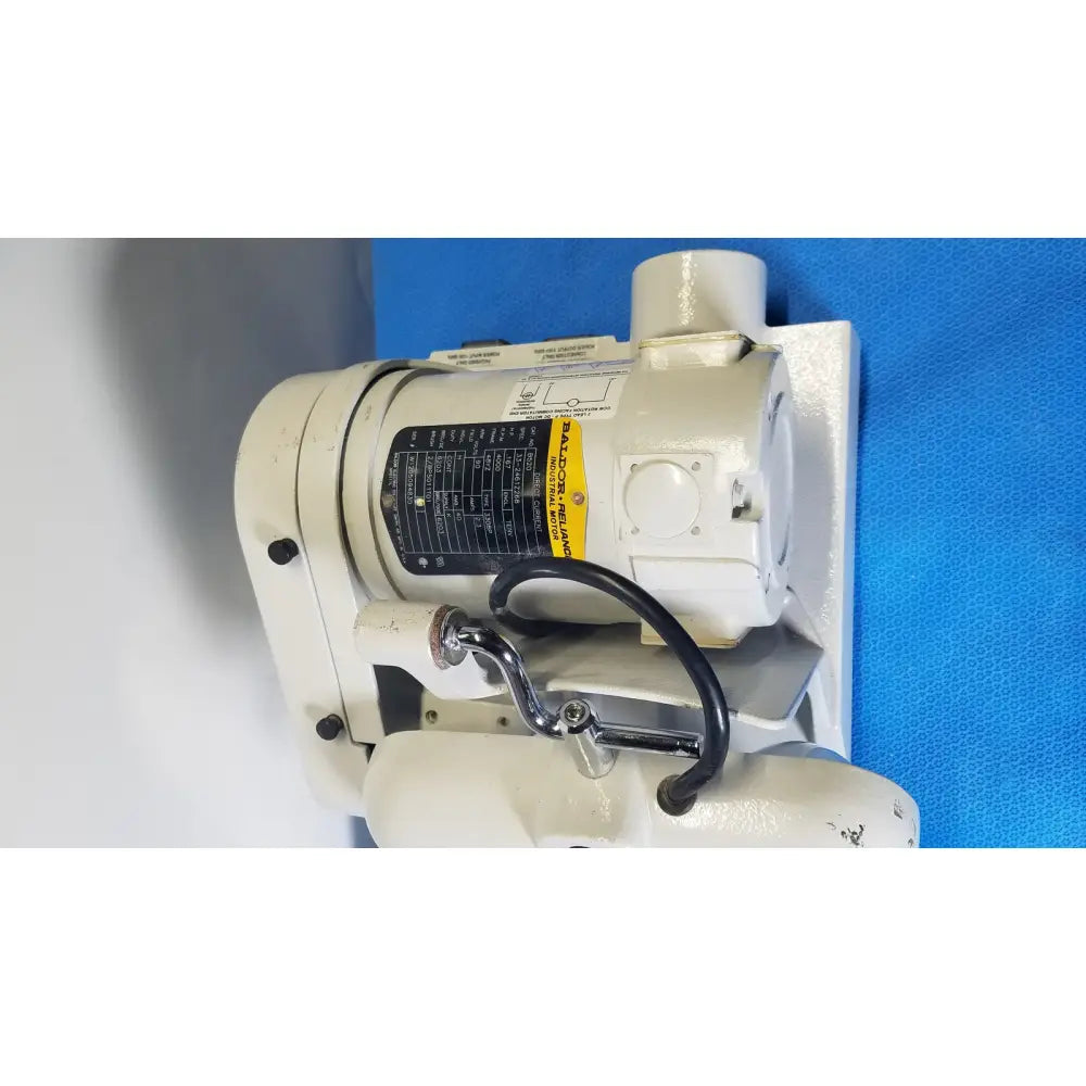 Ray Foster high speed dental alloy grinder with white industrial pump and metallic parts mounted on blue surface