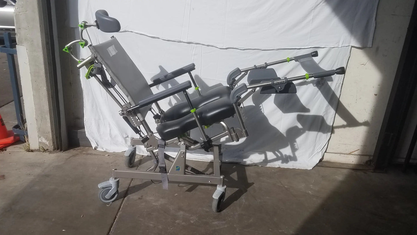 Gray and black adjustable raz attendant tilt shower commode chair with green accent hardware for medical use