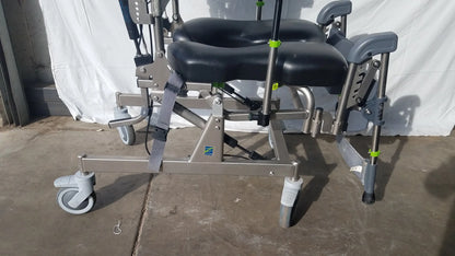Gray and black adjustable raz attendant tilt shower commode chair with padded seat footrest metal frame and caster wheels