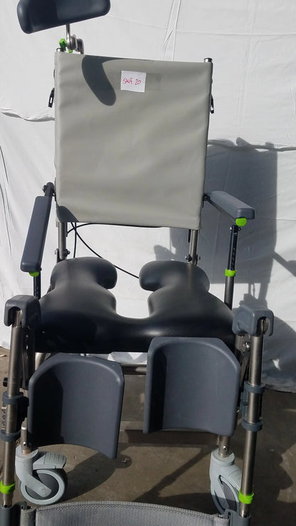 Raz attendant tilt shower commode chair with gray and black adjustable seat and green-accented metal frame commode chair