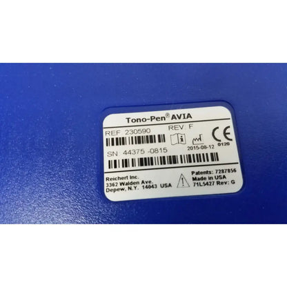 Blue tono pen avia applanation tonometer with white label showing serial number and manufacturer details on back side