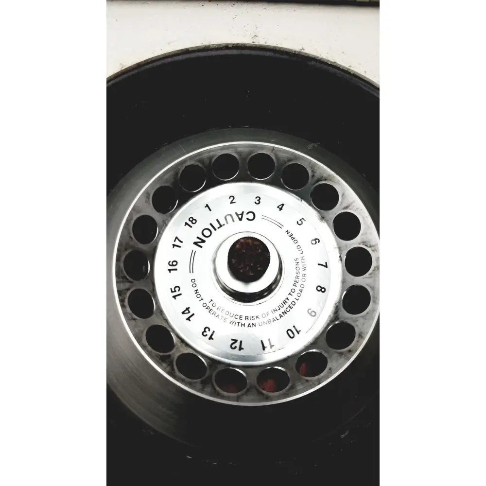 Silver metallic spare tire hubcap with numbered holes and safety warning for reliable scientific quick spin micro centrifuge 115v