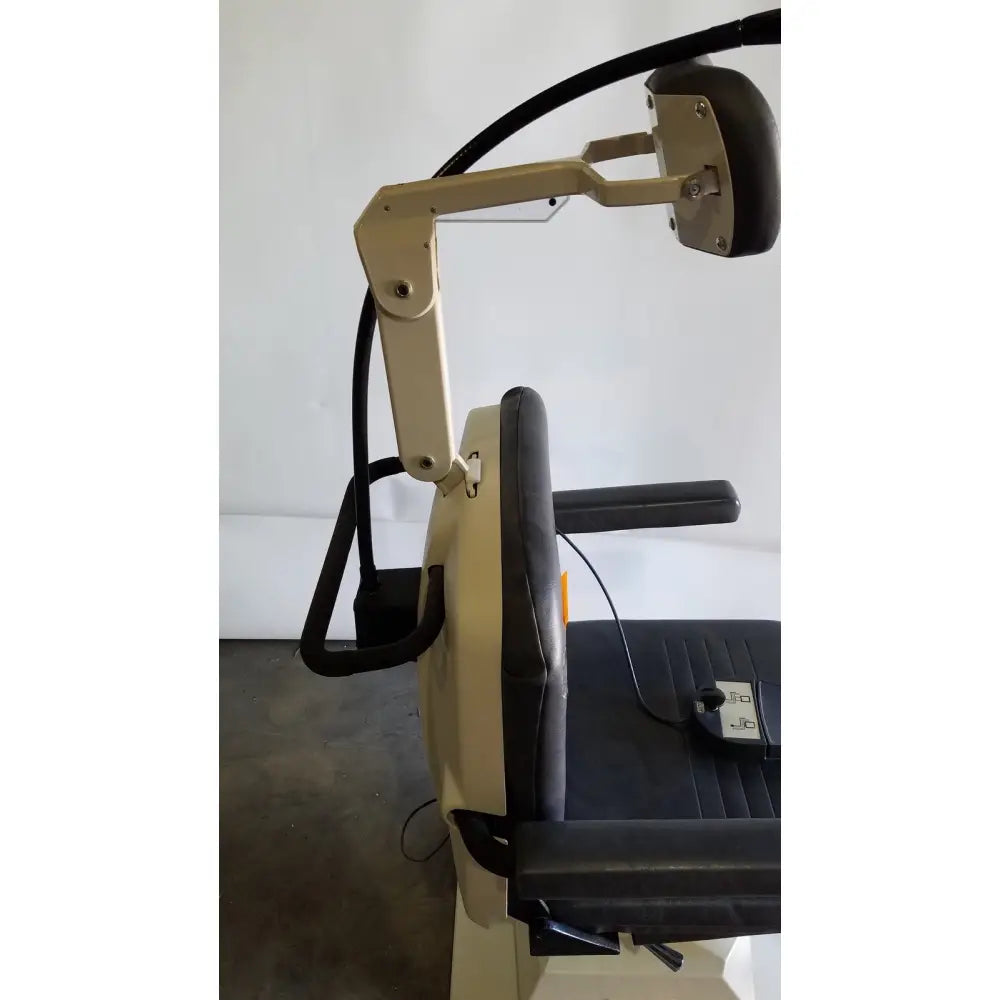 Beige and black adjustable medical examination chair with padded armrests head support by reliance medical products model 6100