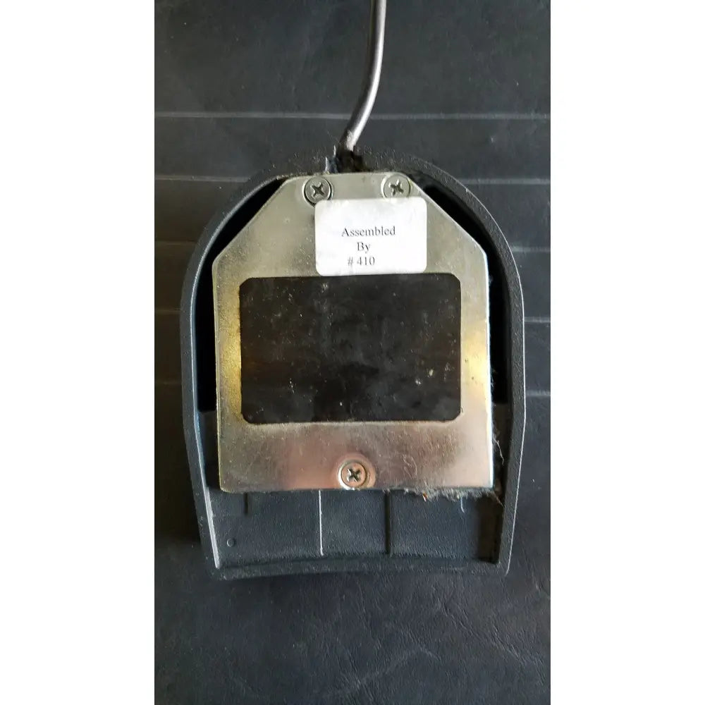 Black plastic foot pedal with metallic silver plate and screws for reliance medical products model 6100 exam chair footswitch