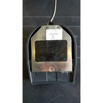 Black plastic foot pedal with metallic silver plate and screws for reliance medical products model 6100 exam chair footswitch