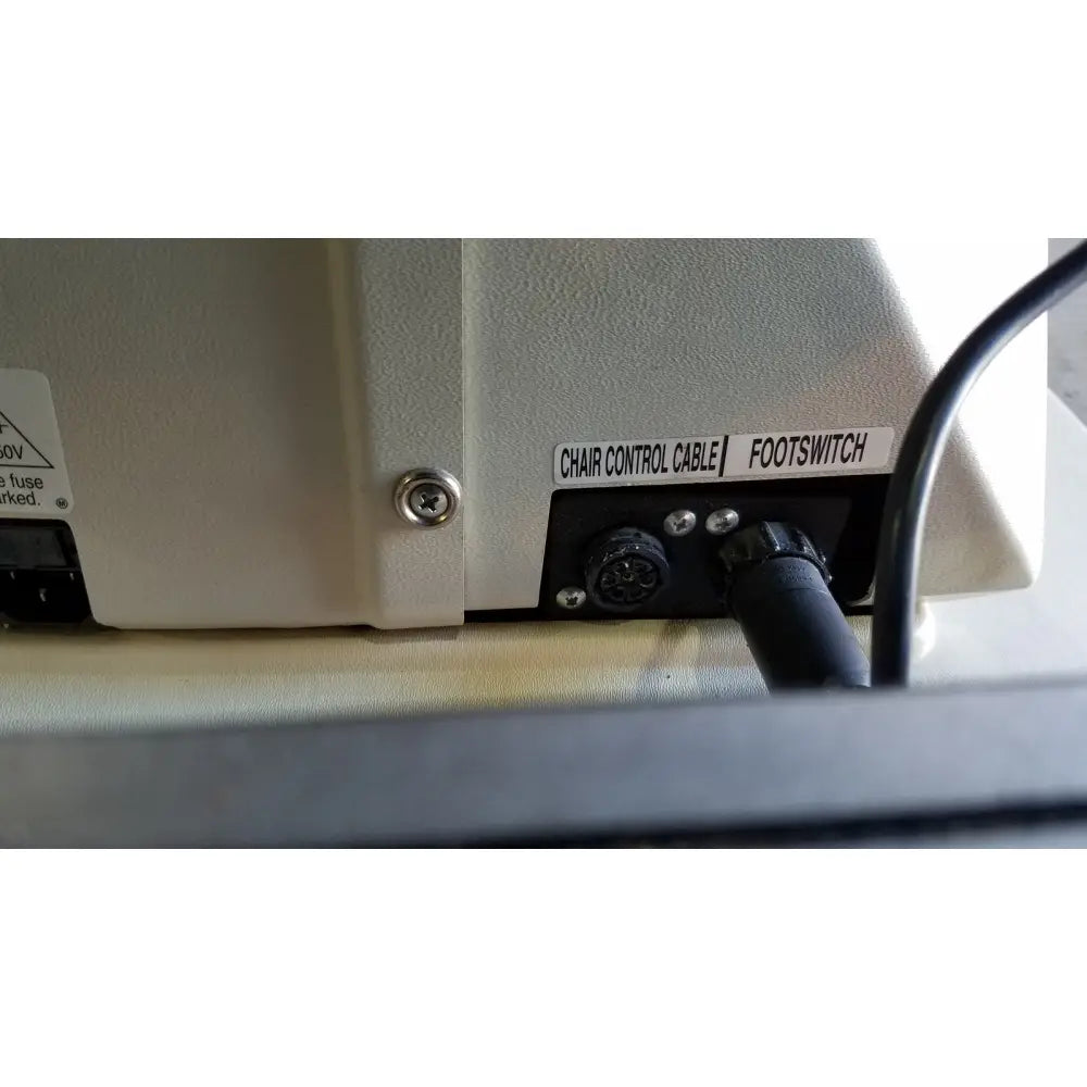 Beige industrial-grade footswitch panel with labeled ports and black connector plug on the back of reliance medical products model 6100 exam chair