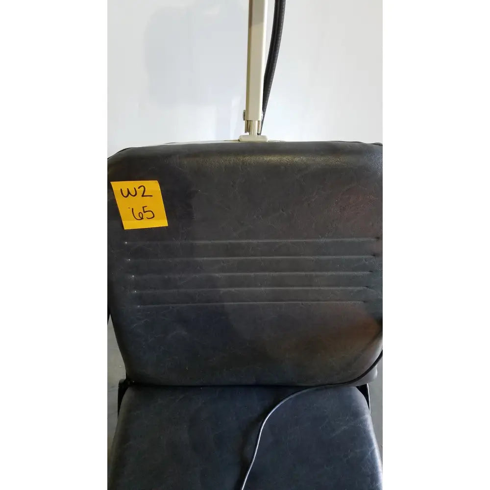 Black vinyl-covered reliance medical products model 6100 exam chair back with ribbed texture and yellow w2 65 label