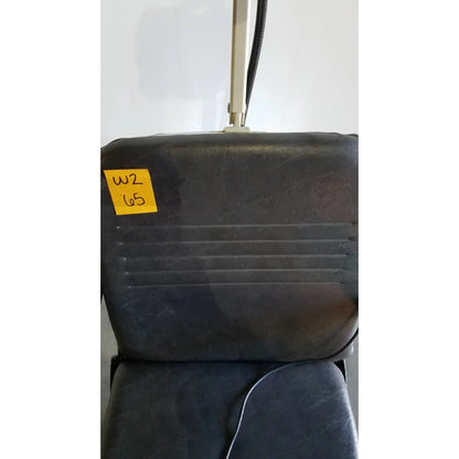 Black vinyl-covered reliance medical products model 6100 exam chair back with ribbed texture and yellow w2 65 label