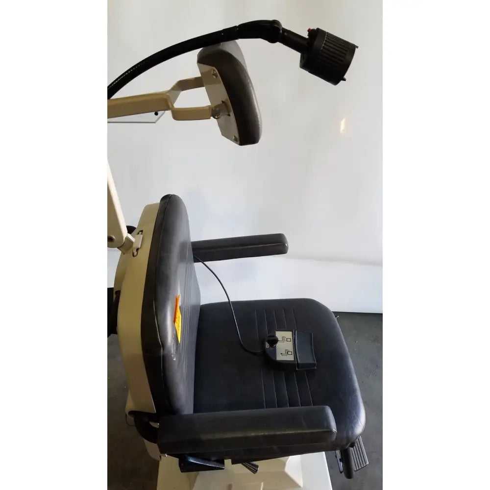 Reliance medical products model 6100 exam chair with black leather seat beige metal frame and adjustable overhead lamp