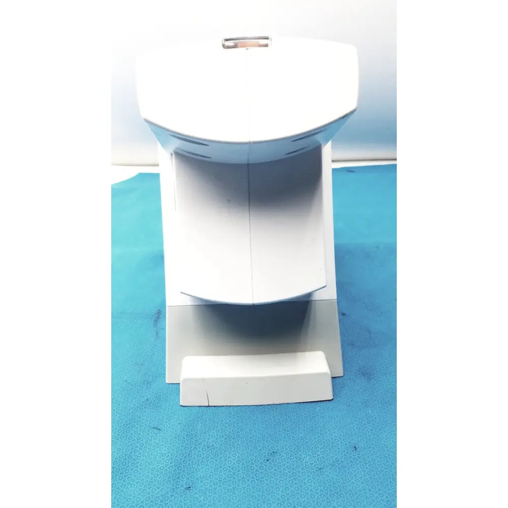 White plastic toilet bowl model with rectangular base and curved front panel used in renfert sympress impression mixing machine setup