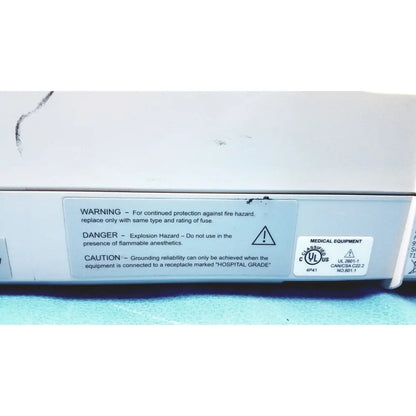 White medical equipment with gray label showing safety warnings and certification marks for mac1200 ekg machines repair service