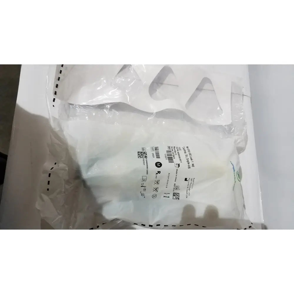 White plastic bag of respironics af531 ee leak genuine oem capstrap single-use with care labels and barcode sealed at top