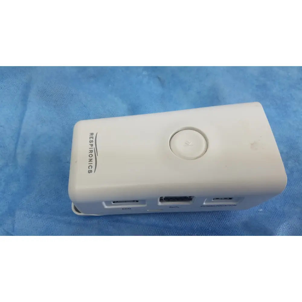 White respironics alice pdx portable sleep diagnostic system showing circular button and multiple usb ports back view
