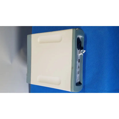 Beige and gray rf assure detection console model 200x with rectangular body and open port revealing internal components