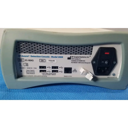 Gray rf assure detection console model 200x with black power switch and usb ports for reliable detection console use