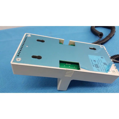 Light blue and white plastic ri-former diagnostic station extension module with one handle and coiled black cable attached