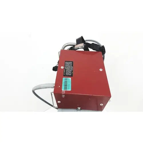 Red rectangular metal fiber light projector with black cables and label by richard wolf showing backside view