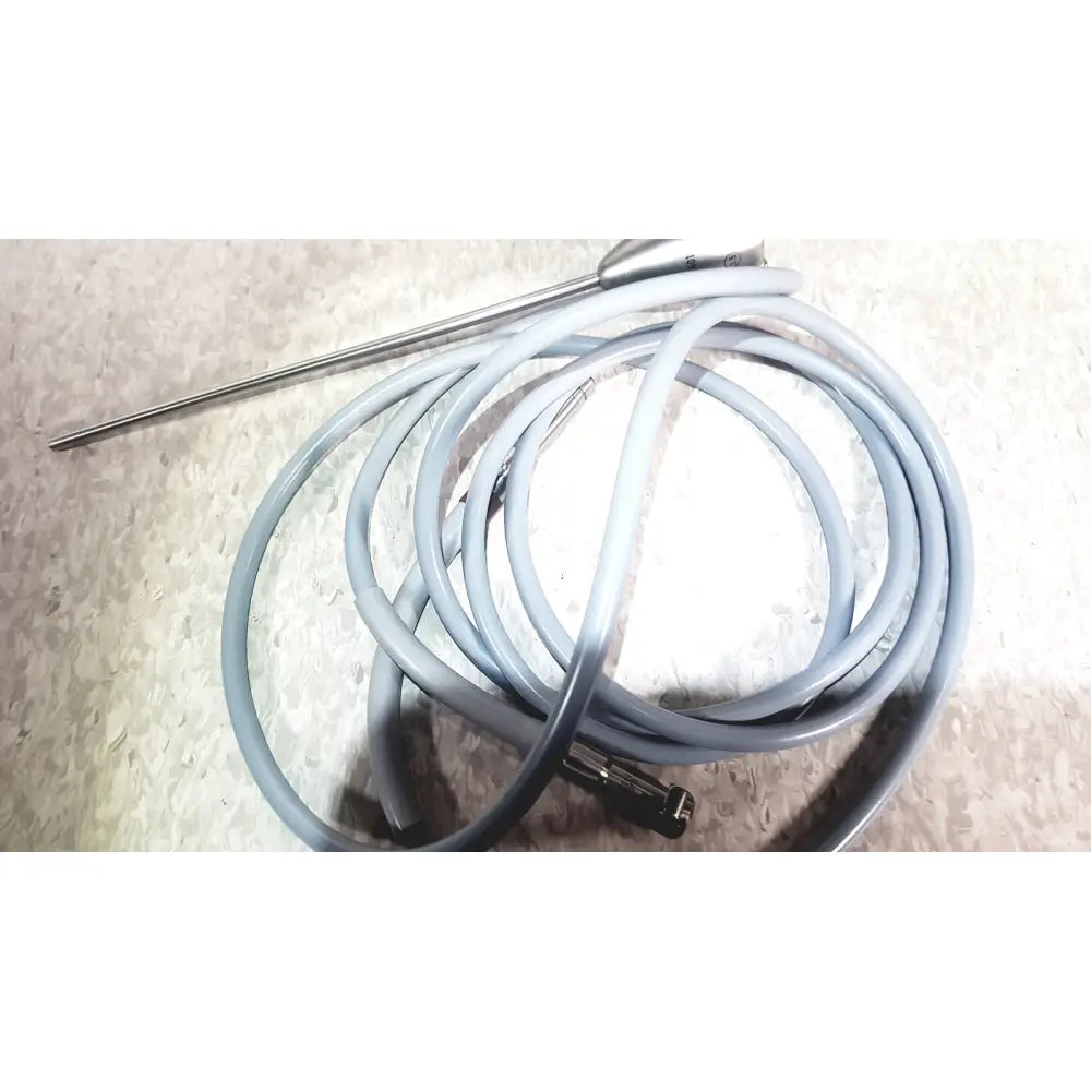 Gray coiled cable with metallic probe and connector in richard wolf 8585.024 mini cystoscope tray for medical use