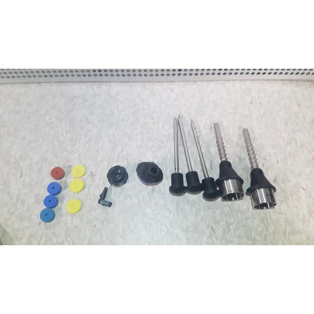 Set of colorful plastic caps, black rubber fittings, and metallic rods in richard wolf 8585.024 mini cystoscope tray