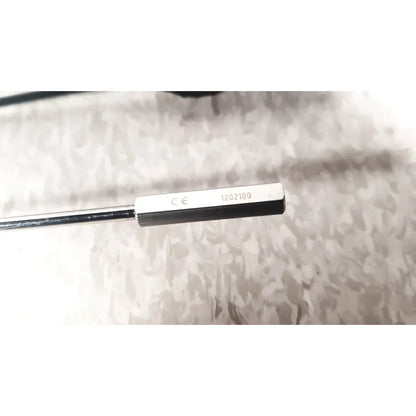 Silver-colored metal sensor with rectangular engraved head in richard wolf mini cystoscope tray for urological use