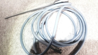 Gray coiled cable with metallic probe and connector in richard wolf 8585.024 mini cystoscope tray for medical use