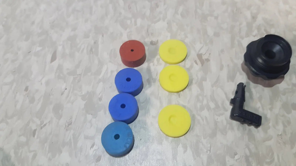 Set of colorful red blue and yellow rubber grommets with black fitting in richard wolf 8585 024 mini cystoscope tray