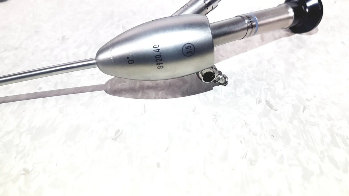 Silver surgical endoscope with sleek metallic body and black-tipped handle in richard wolf 8585.024 mini cystoscope tray