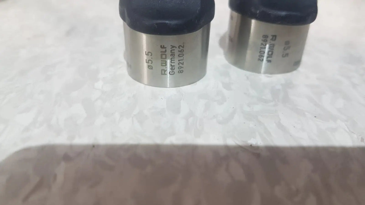 Two metallic cylindrical measuring tools with black rubber tops from richard wolf mini cystoscope tray model 8585.024